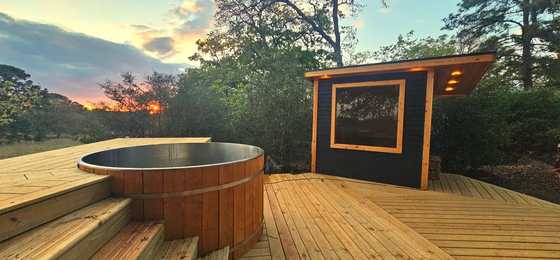 Private wood-fired hot tub deck at dusk