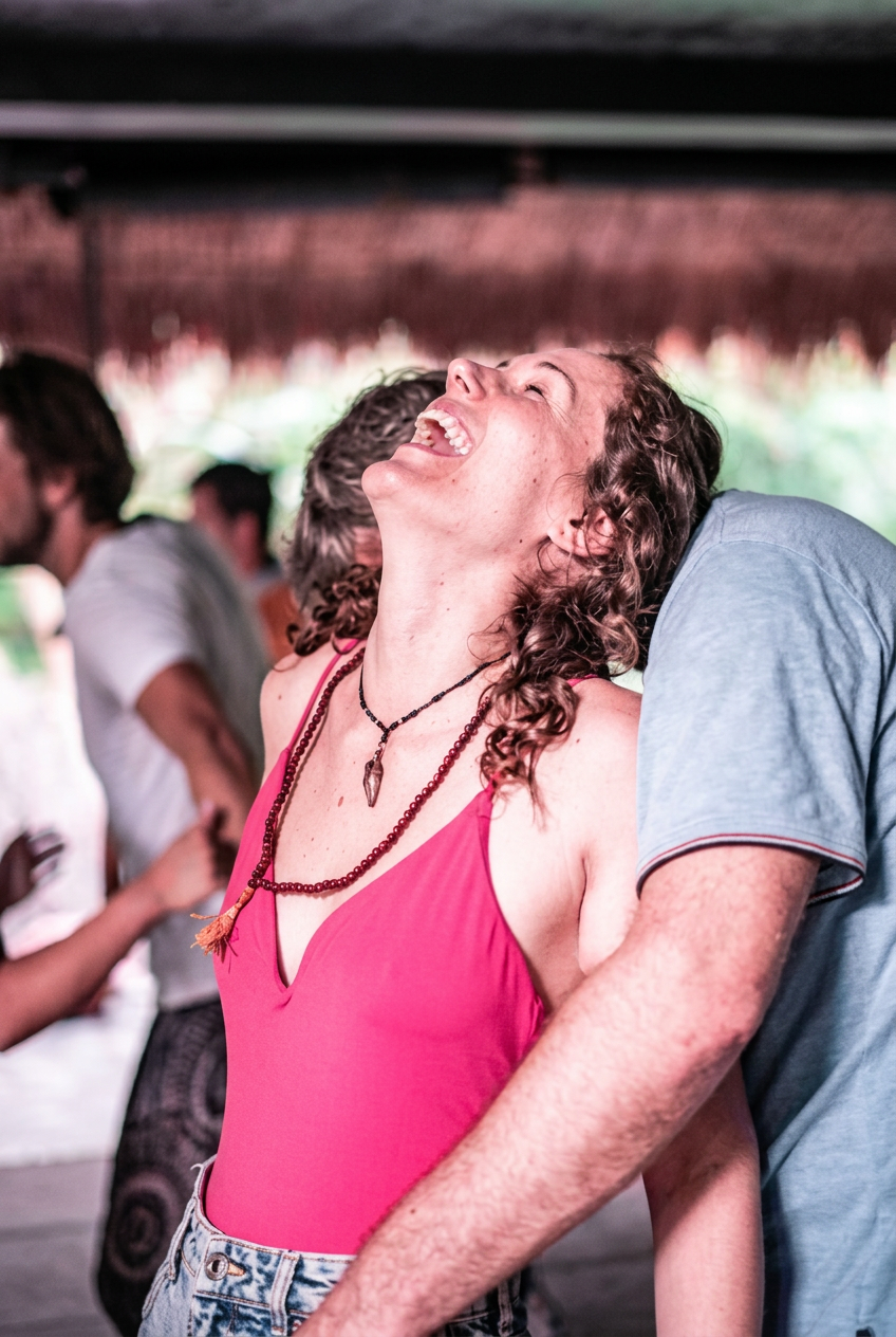 A participant laughing joyfully during a movement session